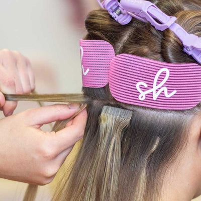 Tape hair extensions being fitted
